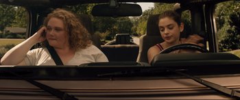 Movie still from “Dumplin'” (2018), directed by Anne Fletcher – Two people in a car looking at a map; Medium shot, Over the shoulder angle
