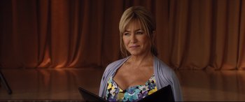 Movie still from “Dumplin'” (2018), directed by Anne Fletcher – A person holding a book; Close Up shot, Over the shoulder angle