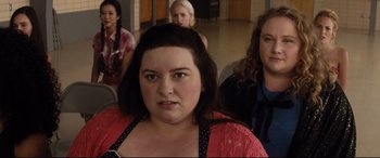 Movie still from “Dumplin'” (2018), directed by Anne Fletcher – A group of people sitting in a room; Close Up shot, Over the shoulder angle