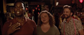 Movie still from “Dumplin'” (2018), directed by Anne Fletcher – A woman standing next to a man in a room; Close Up shot, Over the shoulder angle