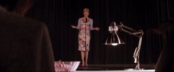 Movie still from “Dumplin'” (2018), directed by Anne Fletcher – A woman standing on a stage holding a microphone; Medium shot, Low angle