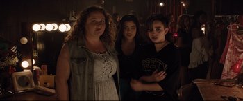 Movie still from “Dumplin'” (2018), directed by Anne Fletcher – A group of women standing next to each other in a room; Medium shot, Over the shoulder angle