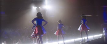 Movie still from “Dumplin'” (2018), directed by Anne Fletcher – A group of young girls in a dance studio performing; Wide shot, Low angle