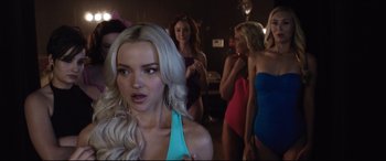 Movie still from “Dumplin'” (2018), directed by Anne Fletcher – A group of women in bathing suits standing in a room; Close Up shot, Over the shoulder angle