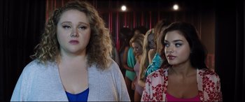 Movie still from “Dumplin'” (2018), directed by Anne Fletcher – A group of women standing next to each other in a room; Medium shot, Over the shoulder angle