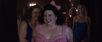 Movie still from “Dumplin'” (2018), directed by Anne Fletcher – A woman in a pink and white polka dot dress; Close Up shot, Over the shoulder angle