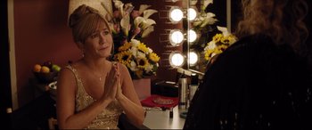Movie still from “Dumplin'” (2018), directed by Anne Fletcher – A woman sitting in front of a mirror in front of flowers; Medium shot, Over the shoulder angle