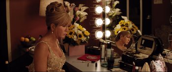 Movie still from “Dumplin'” (2018), directed by Anne Fletcher – A woman sitting in front of a mirror in a dressing room; Medium shot, Over the shoulder angle