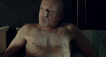 Movie still from “Elegy” (2008), directed by Isabel Coixet – An older man with a shaved head is laying in bed; Close Up shot, High angle