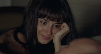 Movie still from “Elegy” (2008), directed by Isabel Coixet – A person with long black hair; Close Up shot, Over the shoulder angle