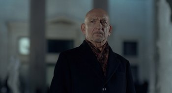 Movie still from “Elegy” (2008), directed by Isabel Coixet – An older man wearing a black coat and a red tie; Close Up shot, Low angle