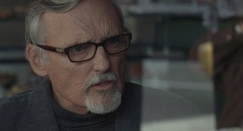 Movie still from “Elegy” (2008), directed by Isabel Coixet – An older man wearing glasses looking at the camera; Close Up shot, Over the shoulder angle