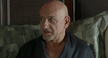 Movie still from “Elegy” (2008), directed by Isabel Coixet – A man with a shaved head is looking at the camera; Close Up shot, Over the shoulder angle