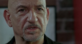 Movie still from “Elegy” (2008), directed by Isabel Coixet – An older man with a shaved head and a goatee looking at the camera; Close Up shot, Low angle
