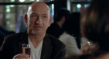 Movie still from “Elegy” (2008), directed by Isabel Coixet – A man with a bald head holding a glass of wine; Close Up shot, Over the shoulder angle