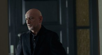 Movie still from “Elegy” (2008), directed by Isabel Coixet – A man with a bald head wearing a black jacket; Close Up shot, Over the shoulder angle