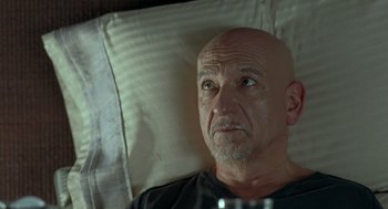Movie still from “Elegy” (2008), directed by Isabel Coixet – An older man laying in a bed looking up at the sky; Close Up shot, Over the shoulder angle
