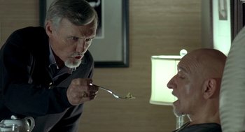Movie still from “Elegy” (2008), directed by Isabel Coixet – An older man holding a spoon in his mouth; Close Up shot, Over the shoulder angle