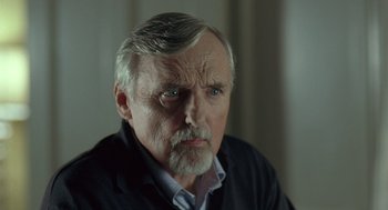 Movie still from “Elegy” (2008), directed by Isabel Coixet – An older man with gray hair wearing a black sweater; Close Up shot, Over the shoulder angle