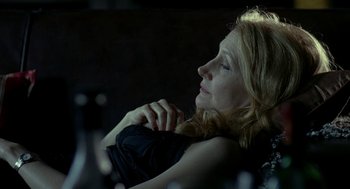 Movie still from “Elegy” (2008), directed by Isabel Coixet – A woman sitting in a chair with her hand on her chin; Close Up shot, High angle