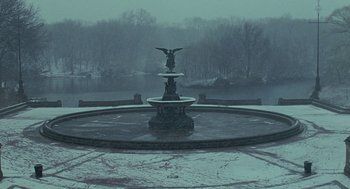 Movie still from “Elegy” (2008), directed by Isabel Coixet – A fountain in the middle of a park on a snowy day; Extreme Wide shot, High angle