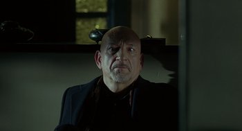 Movie still from “Elegy” (2008), directed by Isabel Coixet – An older man with a shaved head wearing a black jacket; Close Up shot, Low angle