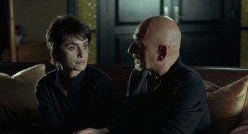 Movie still from “Elegy” (2008), directed by Isabel Coixet – A man and a woman sitting next to each other on a couch; Close Up shot, Over the shoulder angle