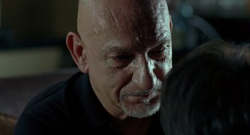 Movie still from “Elegy” (2008), directed by Isabel Coixet – An older man with a shaved head looking down at his face; Close Up shot, Over the shoulder angle