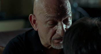 Movie still from “Elegy” (2008), directed by Isabel Coixet – An older man with a shaved head looking down at his face; Close Up shot, Over the shoulder angle