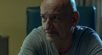 Movie still from “Elegy” (2008), directed by Isabel Coixet – An older man with a shaved head looking at the camera; Close Up shot, Low angle