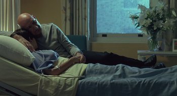 Movie still from “Elegy” (2008), directed by Isabel Coixet – A man laying in bed next to a window; Medium shot, Over the shoulder angle