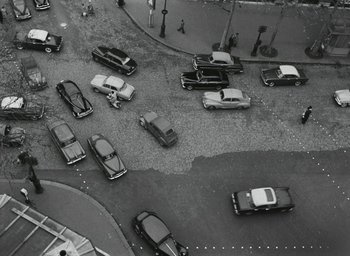 Movie still from “Elevator to the Gallows” (1958), directed by Louis Malle – An aerial view of a busy street with cars parked on it; Extreme Wide shot, Overhead angle