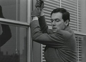 Movie still from “Elevator to the Gallows” (1958), directed by Louis Malle – A black and white photo of a man holding a leather glove; Close Up shot, Low angle