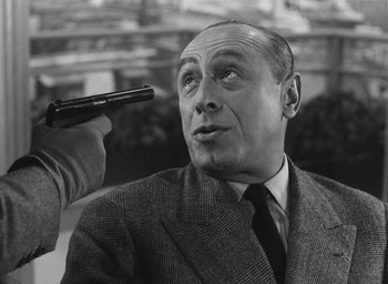 Movie still from “Elevator to the Gallows” (1958), directed by Louis Malle – An old black and white photo of a man holding a gun up to his head; Close Up shot, Over the shoulder angle