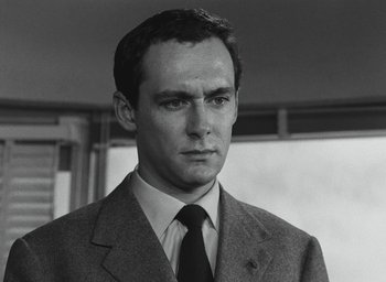 Movie still from “Elevator to the Gallows” (1958), directed by Louis Malle – Black and white photograph of a man wearing a suit and tie; Close Up shot, Low angle