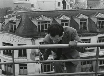 Movie still from “Elevator to the Gallows” (1958), directed by Louis Malle – A black and white photo of a man on a railing; Medium shot, Low angle