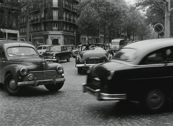 Movie still from “Elevator to the Gallows” (1958), directed by Louis Malle – A black and white photo of a busy city street; Wide shot, High angle