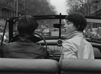 Movie still from “Elevator to the Gallows” (1958), directed by Louis Malle – Two people sitting in the back seat of a car; Medium shot, Over the shoulder angle