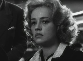 Movie still from “Elevator to the Gallows” (1958), directed by Louis Malle – A black and white photo of a woman with blonde hair; Close Up shot, Over the shoulder angle