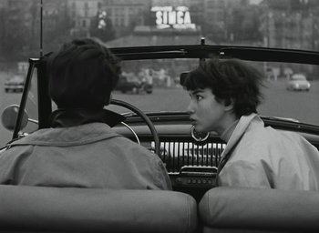Movie still from “Elevator to the Gallows” (1958), directed by Louis Malle – Two people sitting in the back seat of a car; Medium shot, Over the shoulder angle