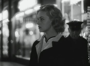 Movie still from “Elevator to the Gallows” (1958), directed by Louis Malle – A black and white photo of a woman looking at the camera; Close Up shot, Over the shoulder angle