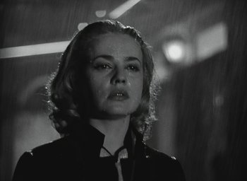 Movie still from “Elevator to the Gallows” (1958), directed by Louis Malle – A black - and - white photo of a woman in the rain; Close Up shot, Low angle
