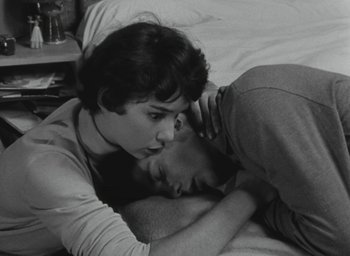 Movie still from “Elevator to the Gallows” (1958), directed by Louis Malle – A man and a woman laying on a bed; Close Up shot, High angle