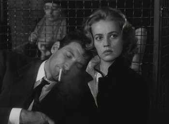 Movie still from “Elevator to the Gallows” (1958), directed by Louis Malle – A man and a woman are smoking a cigarette; Close Up shot, Low angle
