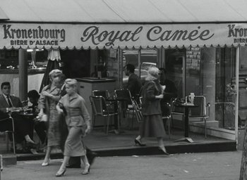Movie still from “Elevator to the Gallows” (1958), directed by Louis Malle – A black - and - white photo of people walking on the sidewalk; Wide shot, High angle