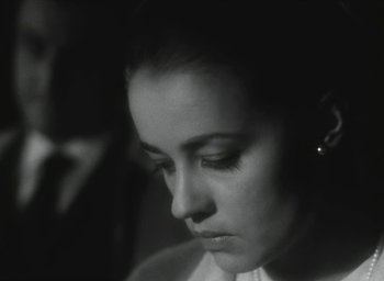 Movie still from “Elevator to the Gallows” (1958), directed by Louis Malle – A person wearing a white shirt; Close Up shot, Over the shoulder angle