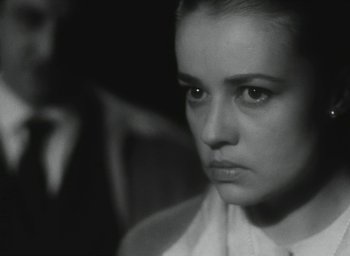 Movie still from “Elevator to the Gallows” (1958), directed by Louis Malle – A black - and - white photo of a woman looking sad; Close Up shot, Over the shoulder angle