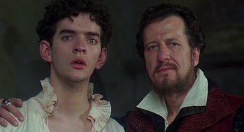 Movie still from “Elizabeth” (1998), directed by Shekhar Kapur – A man and a young boy standing next to each other; Close Up shot, Over the shoulder angle