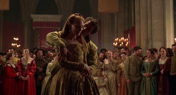 Movie still from “Elizabeth” (1998), directed by Shekhar Kapur – A man and a woman dancing in front of a crowd; Medium shot, Low angle