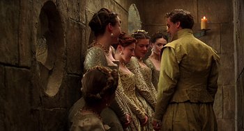 Movie still from “Elizabeth” (1998), directed by Shekhar Kapur – A group of people dressed in medieval clothing; Medium shot, Over the shoulder angle